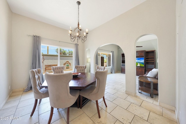 6911 E Thunderbird Rd, Scottsdale, AZ 85254 - dining room featuring arched walkways and a chandelier