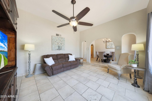 6911 E Thunderbird Rd, Scottsdale, AZ 85254 - living area with arched walkways, a ceiling fan, light tile patterned flooring, and a chandelier