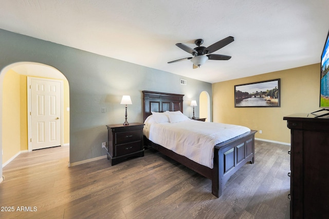 6911 E Thunderbird Rd, Scottsdale, AZ 85254 - bedroom featuring arched walkways, wood finished floors, and a ceiling fan