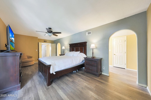 6911 E Thunderbird Rd, Scottsdale, AZ 85254 - bedroom with arched walkways, wood finished floors, and a ceiling fan