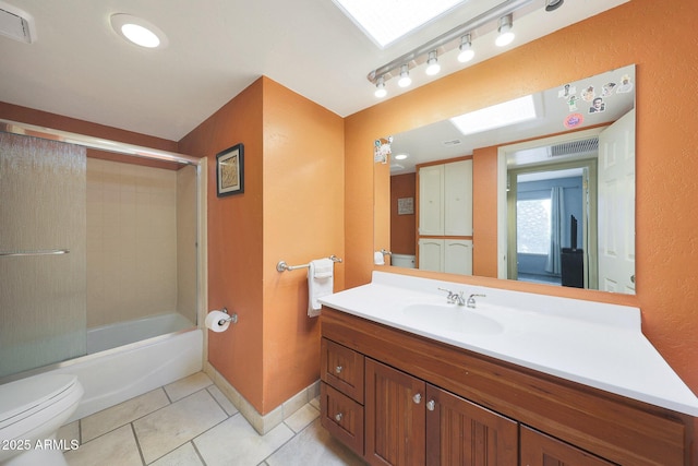 6911 E Thunderbird Rd, Scottsdale, AZ 85254 - full bath featuring tile patterned flooring, vanity, bath / shower combo with glass door, and a skylight