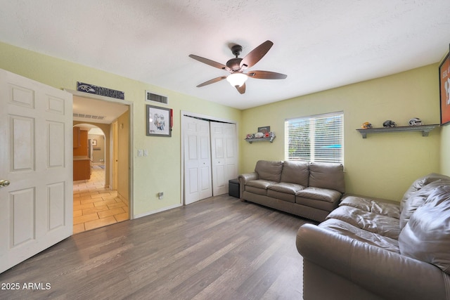 6911 E Thunderbird Rd, Scottsdale, AZ 85254 - living area with a ceiling fan, arched walkways, and wood finished floors