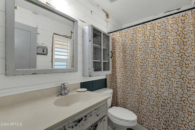 bathroom featuring vanity, a shower with curtain, toilet, and wooden walls