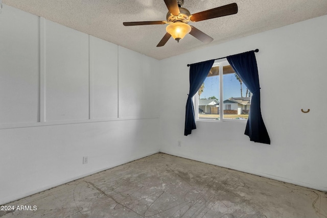 empty room featuring ceiling fan and a textured ceiling