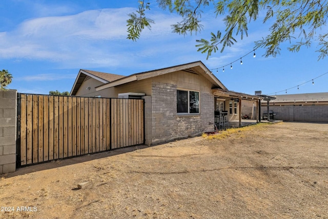 view of side of home with a patio