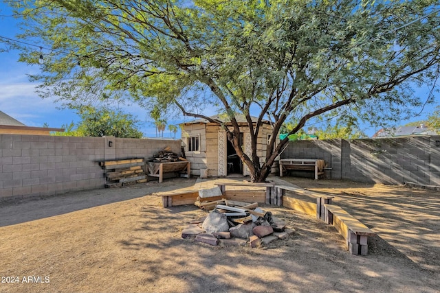 exterior space featuring a fire pit and a shed