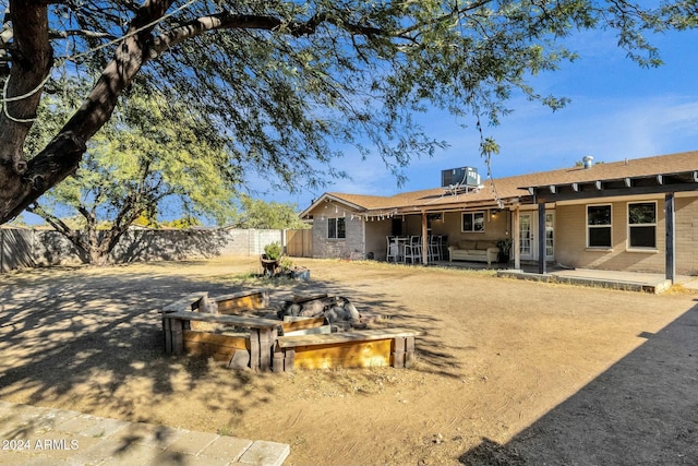 rear view of house with cooling unit and a patio