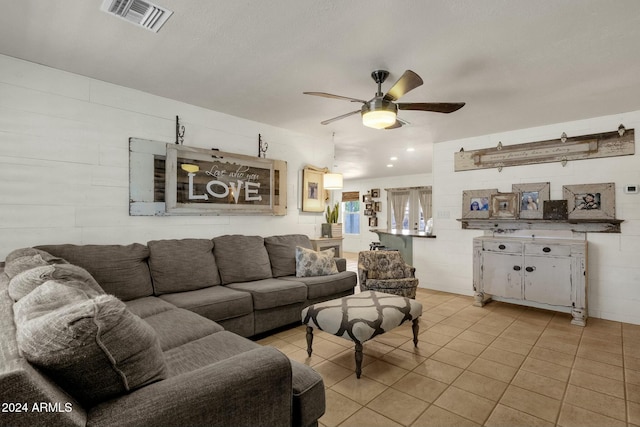 living room with light tile patterned floors and ceiling fan