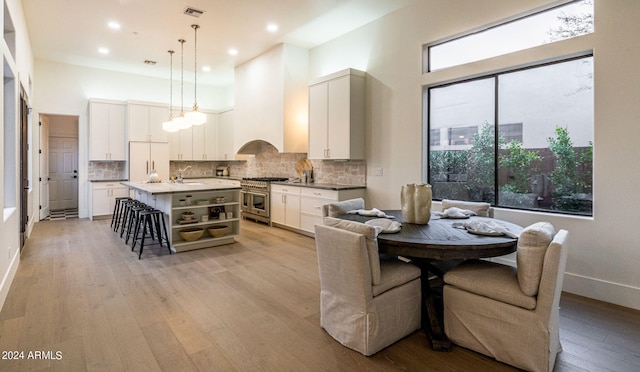 dining area with sink and light wood-type flooring