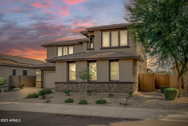 14655 W Pasadena Ave, Litchfield Park, AZ 85340 - prairie-style home with fence, stone siding, and stucco siding