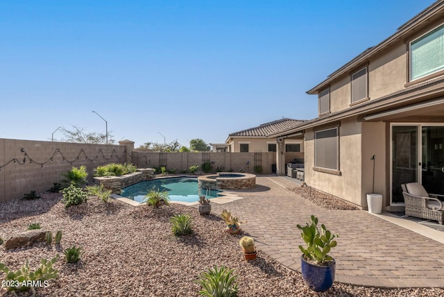 14655 W Pasadena Ave, Litchfield Park, AZ 85340 - view of swimming pool featuring a patio area, a fenced backyard, and a pool with connected hot tub