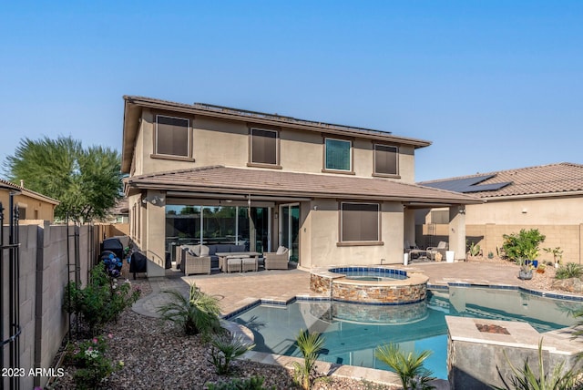 14655 W Pasadena Ave, Litchfield Park, AZ 85340 - rear view of house featuring an outdoor hangout area, a pool with connected hot tub, a fenced backyard, stucco siding, and a patio