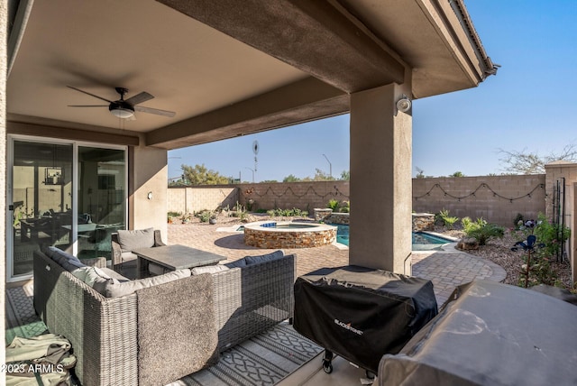 14655 W Pasadena Ave, Litchfield Park, AZ 85340 - view of patio featuring ceiling fan, a pool with connected hot tub, a fenced backyard, an outdoor living space, and grilling area