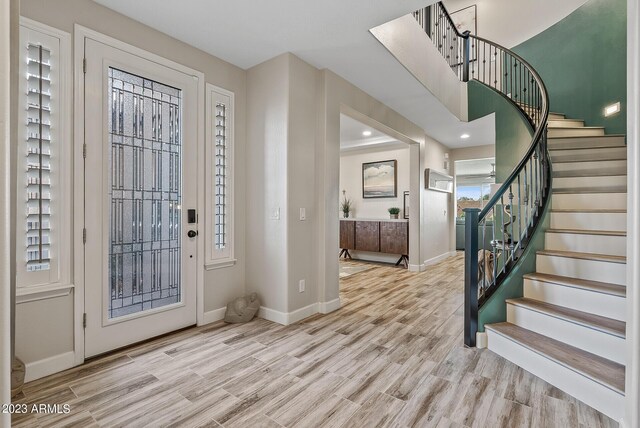 14655 W Pasadena Ave, Litchfield Park, AZ 85340 - entrance foyer featuring stairway, light wood-style flooring, and baseboards
