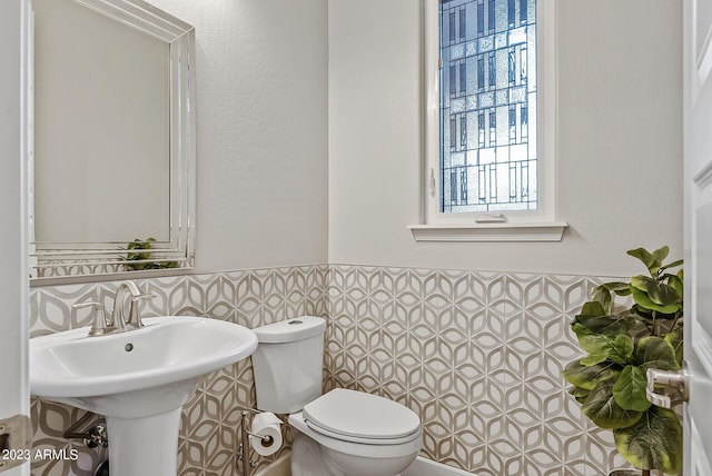 14655 W Pasadena Ave, Litchfield Park, AZ 85340 - half bath featuring wainscoting, tile walls, and toilet