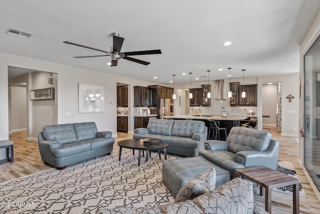 14655 W Pasadena Ave, Litchfield Park, AZ 85340 - living room with visible vents, baseboards, a ceiling fan, and light wood-style flooring