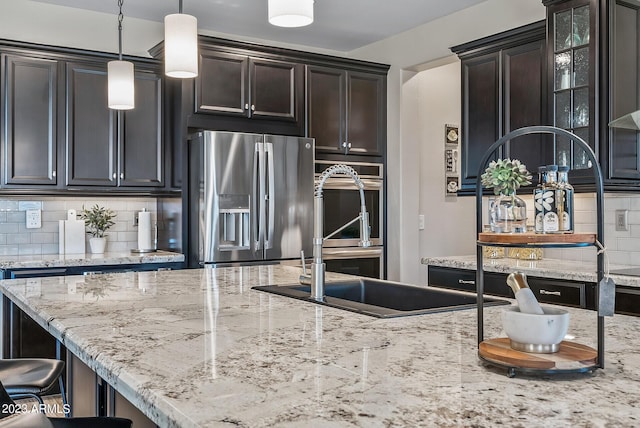 14655 W Pasadena Ave, Litchfield Park, AZ 85340 - kitchen featuring backsplash, a sink, stainless steel fridge, and light stone countertops