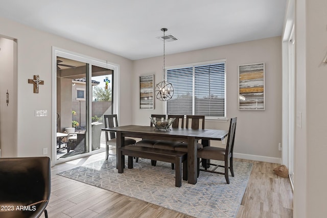 14655 W Pasadena Ave, Litchfield Park, AZ 85340 - dining space featuring a notable chandelier, visible vents, baseboards, and light wood-style flooring