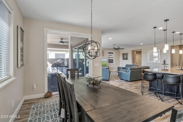 14655 W Pasadena Ave, Litchfield Park, AZ 85340 - dining area with plenty of natural light, light wood-style floors, and ceiling fan with notable chandelier