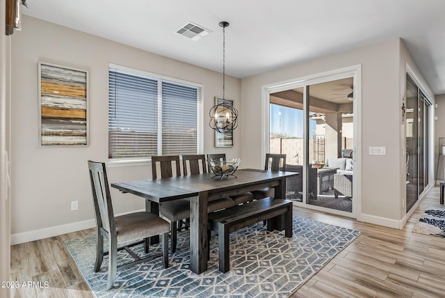 14655 W Pasadena Ave, Litchfield Park, AZ 85340 - dining space featuring visible vents, baseboards, light wood-type flooring, and ceiling fan with notable chandelier