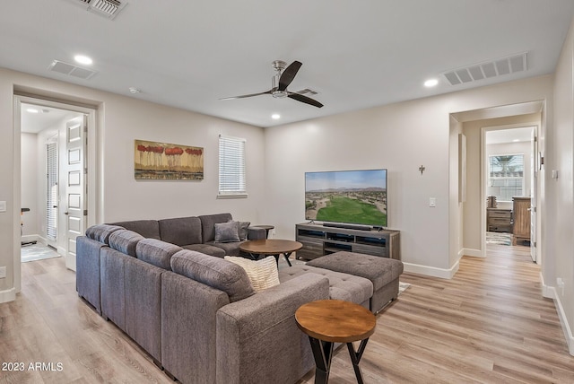 14655 W Pasadena Ave, Litchfield Park, AZ 85340 - living room with light wood finished floors, visible vents, baseboards, and a ceiling fan