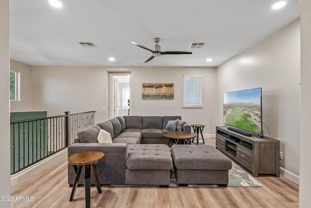 14655 W Pasadena Ave, Litchfield Park, AZ 85340 - living area featuring light wood-style flooring, a healthy amount of sunlight, and visible vents