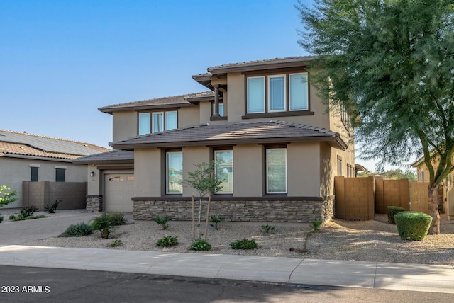 14655 W Pasadena Ave, Litchfield Park, AZ 85340 - prairie-style house with a garage, stucco siding, stone siding, and fence