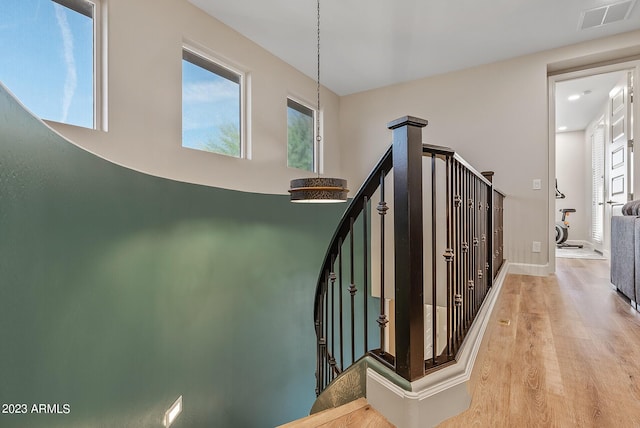 14655 W Pasadena Ave, Litchfield Park, AZ 85340 - stairway featuring wood finished floors, baseboards, and visible vents