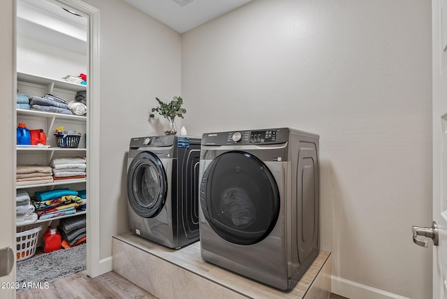 14655 W Pasadena Ave, Litchfield Park, AZ 85340 - washroom with washing machine and dryer, laundry area, baseboards, and wood finished floors