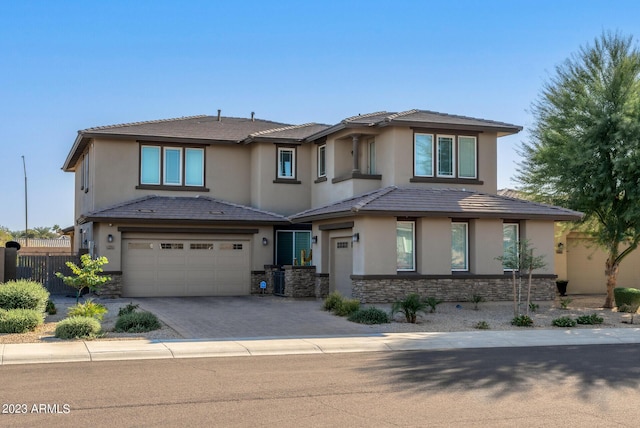 14655 W Pasadena Ave, Litchfield Park, AZ 85340 - prairie-style home with a garage, stucco siding, fence, stone siding, and driveway
