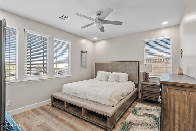14655 W Pasadena Ave, Litchfield Park, AZ 85340 - bedroom featuring light wood finished floors, visible vents, multiple windows, and baseboards