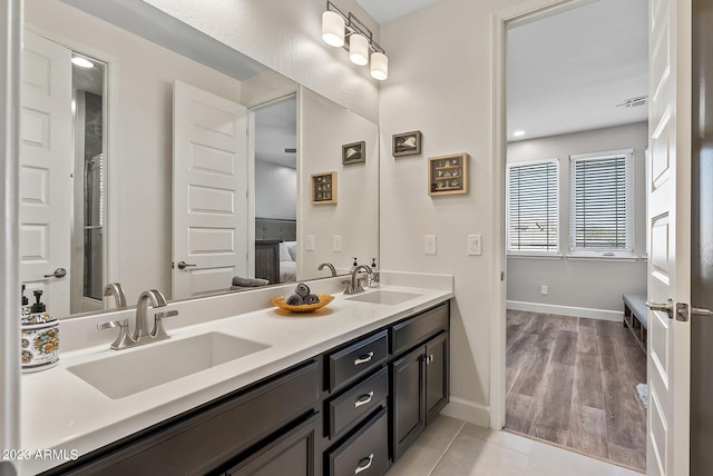 14655 W Pasadena Ave, Litchfield Park, AZ 85340 - ensuite bathroom featuring a sink, ensuite bathroom, baseboards, and double vanity
