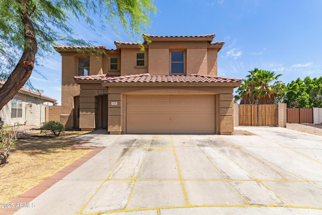 304 E Beth Dr, Phoenix, AZ 85042 - mediterranean / spanish home with concrete driveway, stucco siding, fence, a gate, and a tiled roof