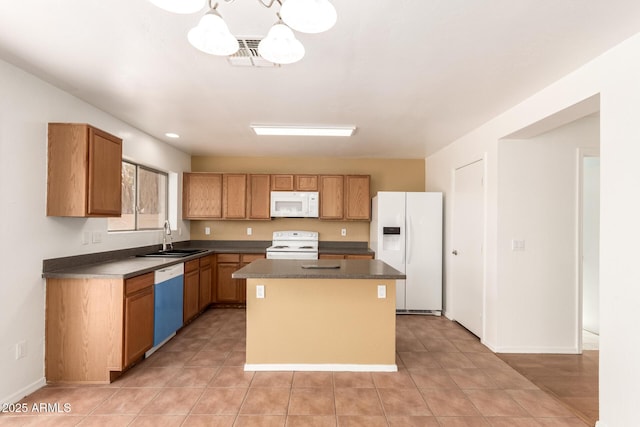 304 E Beth Dr, Phoenix, AZ 85042 - kitchen featuring white appliances, a sink, a center island, dark countertops, and light tile patterned floors