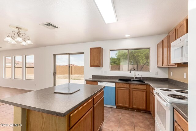 304 E Beth Dr, Phoenix, AZ 85042 - kitchen featuring white appliances, a sink, dark countertops, light tile patterned flooring, and recessed lighting