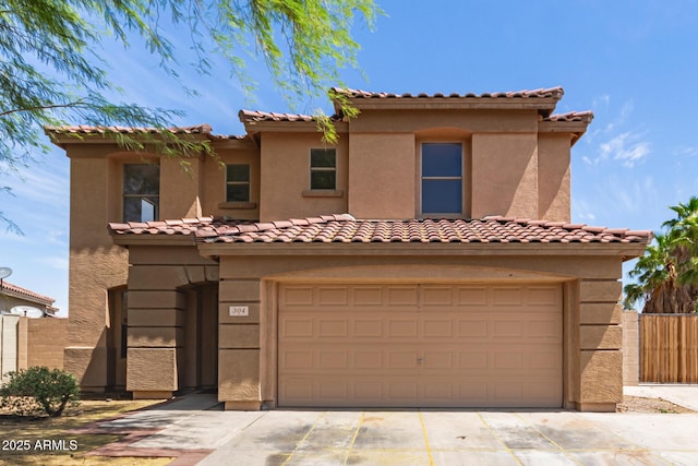 304 E Beth Dr, Phoenix, AZ 85042 - mediterranean / spanish-style home with an attached garage, driveway, stucco siding, and fence