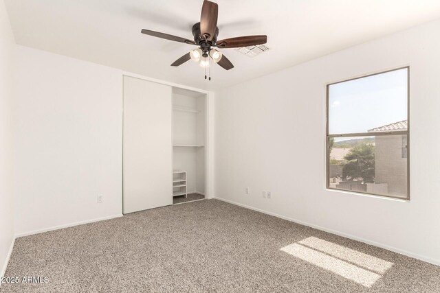 304 E Beth Dr, Phoenix, AZ 85042 - unfurnished bedroom with carpet, a closet, a ceiling fan, and baseboards
