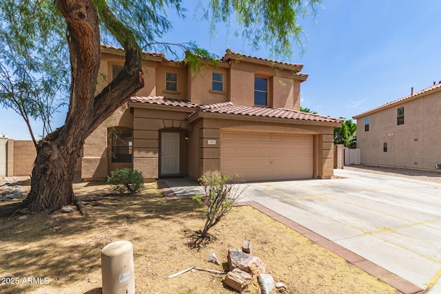 304 E Beth Dr, Phoenix, AZ 85042 - mediterranean / spanish house featuring stucco siding, concrete driveway, a tile roof, fence, and a garage