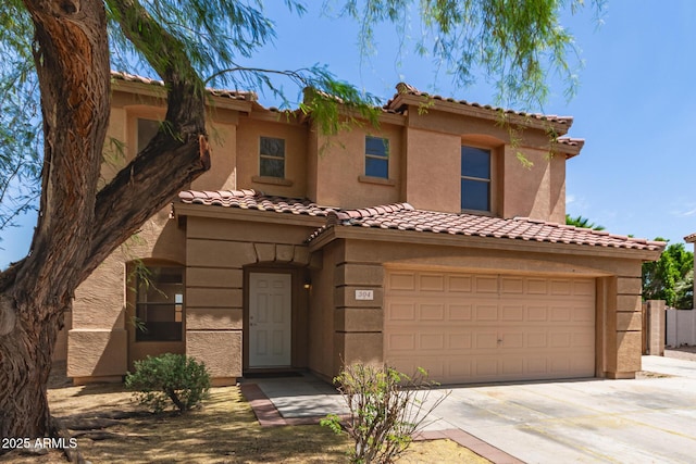 304 E Beth Dr, Phoenix, AZ 85042 - mediterranean / spanish home with a garage, driveway, stucco siding, and a tiled roof