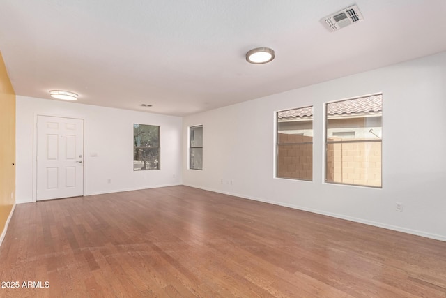 304 E Beth Dr, Phoenix, AZ 85042 - unfurnished room with wood finished floors and baseboards