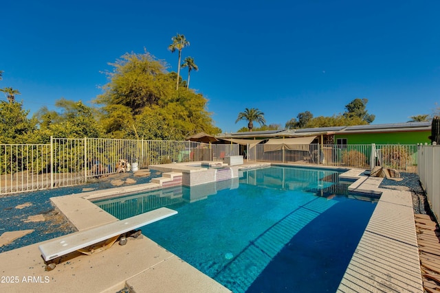 view of swimming pool featuring a patio, a diving board, and an in ground hot tub