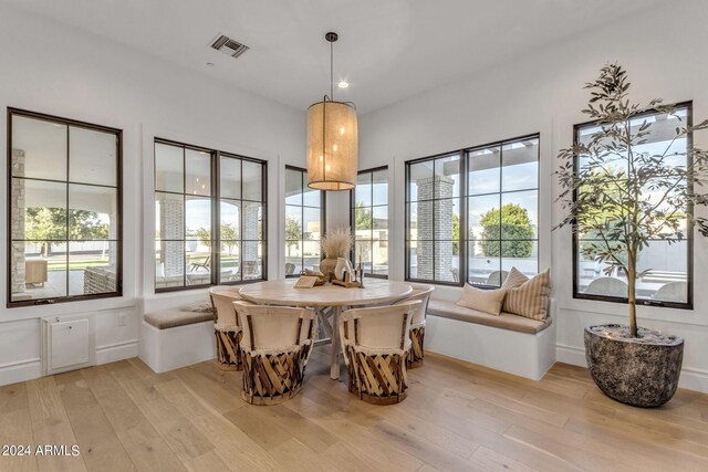 dining space featuring light wood-type flooring and a healthy amount of sunlight