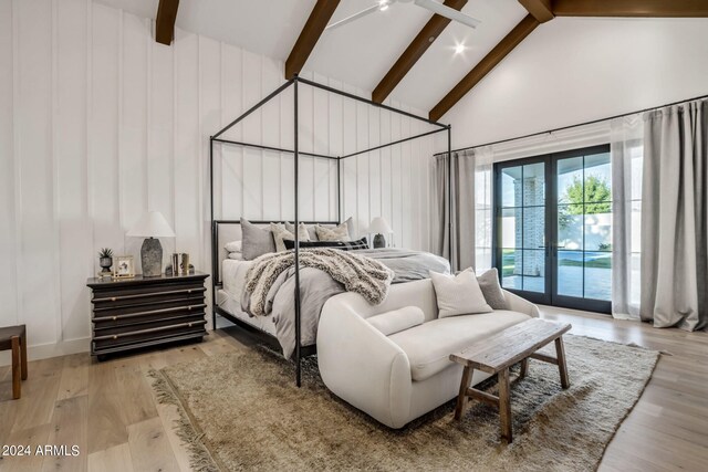 bedroom featuring high vaulted ceiling, access to outside, french doors, and light hardwood / wood-style floors