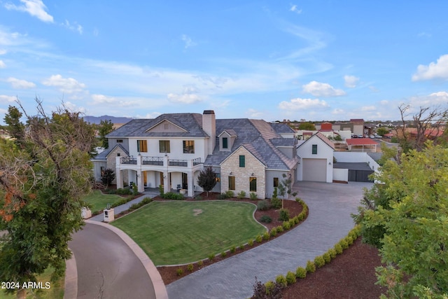 view of front of home with a garage and a front lawn