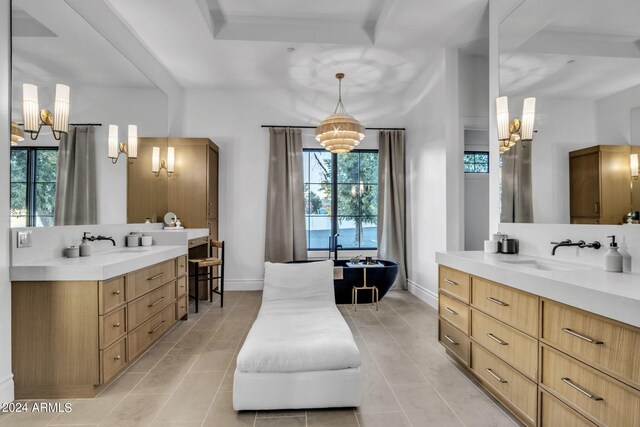 bathroom featuring a notable chandelier, dual vanity, and tile patterned flooring