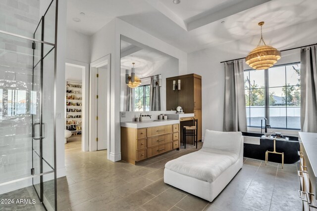 bathroom featuring vanity, plus walk in shower, and tile patterned flooring