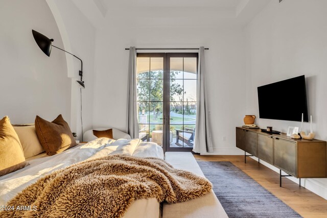 bedroom featuring access to exterior and light hardwood / wood-style flooring