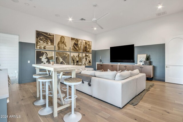 living room featuring ceiling fan and light hardwood / wood-style floors