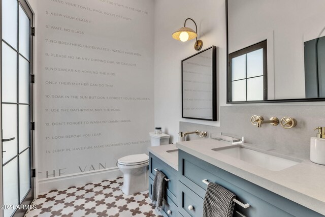 bathroom featuring vanity, toilet, and tile patterned floors