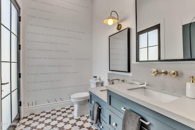 bathroom with toilet and vanity